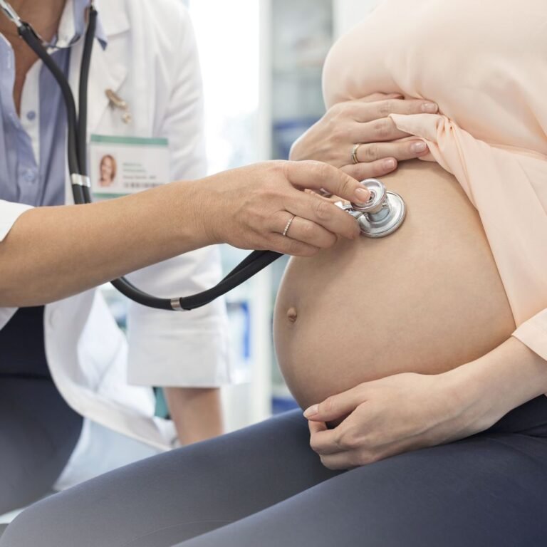 doctor-using-stethoscope-on-pregnant-patients-stomach-595348651-59932a7968e1a2001113f56d